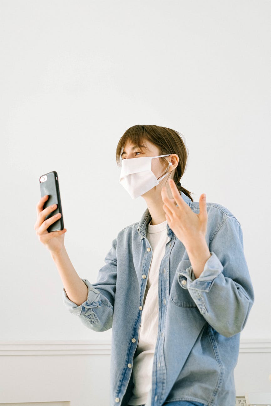 woman with a face mask having a video call